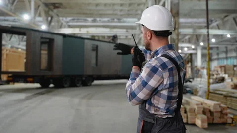 Construction worker coordinating modular home transportation Stock Footage 301824811
