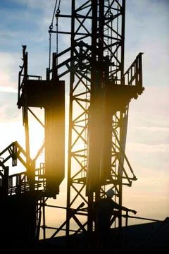 Construction worker, crane and building at sunset Stock-Fotos