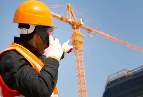 Construction worker with crane in background Stock Photos