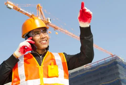 Construction worker with crane in background Foto stock