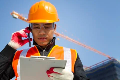 Construction worker with crane in background Stock Photos