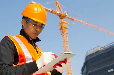 Construction worker with crane in background Foto stock