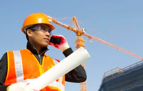 Construction worker with crane in background Foto stock