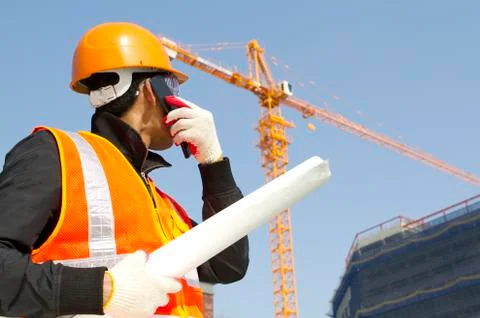 Construction worker with crane in background Foto stock