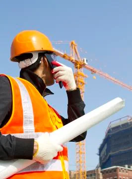 Construction worker with crane in background Stock Photos