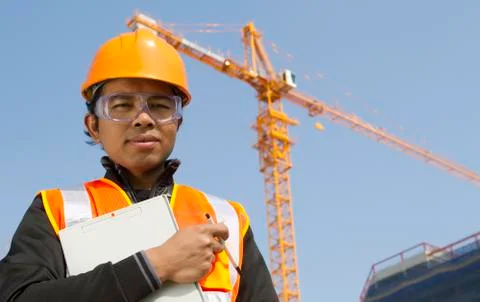 Construction worker with crane in background Foto stock