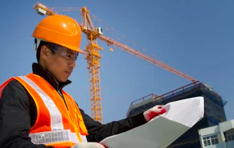 Construction worker with crane in background Stock Photos