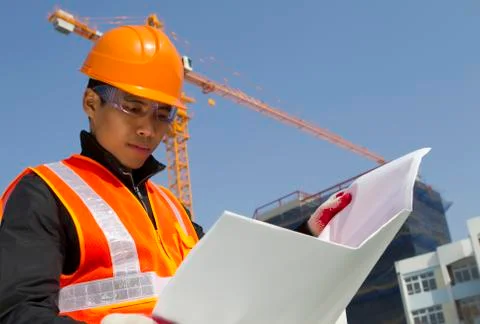 Construction worker with crane in background Foto stock