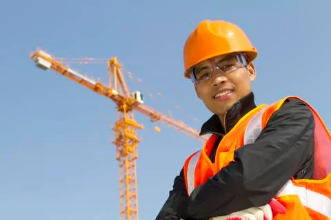 Construction worker with crane in background Stock Photos