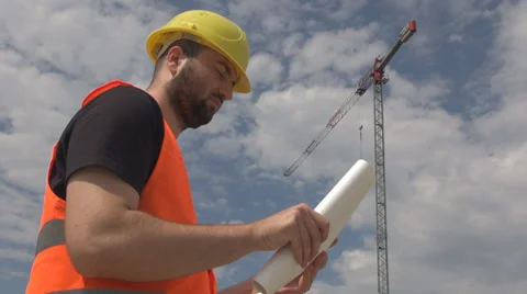 Construction worker, with crash-helmet, engineer, studying the plan,site, crane Stock Footage 39500470