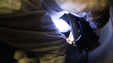 Construction worker crawling through tube or pipe 動画素材 123727942