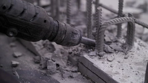 Construction worker crumbles concrete with a jackhammer Stock Footage 247546602