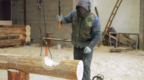 Construction worker cuts a groove in the tree for a future home. Protective mask Stock Footage 69038837