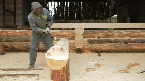 Construction worker cuts a groove in the tree for a future home. Protective mask Stock Footage 69066948