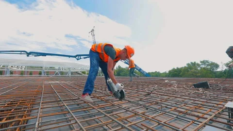 Construction worker cuts rebar with circular saw. A man works with a circular Video stock 167010677