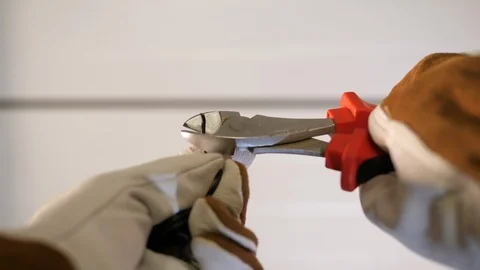 Construction worker cuts wire with heavy duty cable Cutters Stripper. POV. Vídeos de archivo 126336570