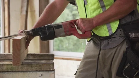 Construction worker cutting board with saw Video stock 84563294