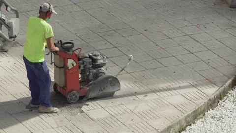 Construction worker cutting concrete floor on a sidewalk Video stock 139485110