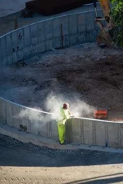 Construction worker cutting concrete with a power tool Stock Photos