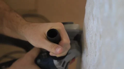Construction worker cutting a groove in the wall with a grinder Stock Footage 319788559