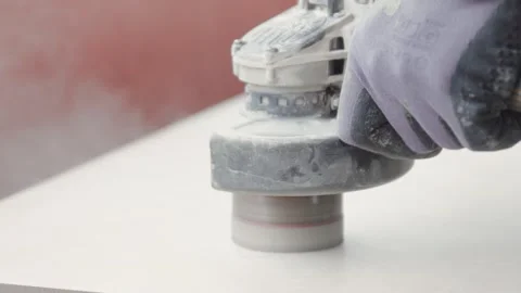 Construction worker cutting a hole in a tile with a circular power tool. Stock Footage 342926024