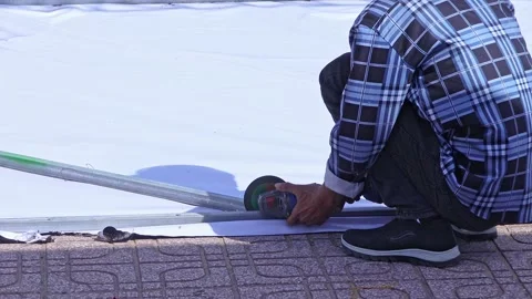 Construction worker cutting metal frame with angle grinder. Stock Footage 336663649