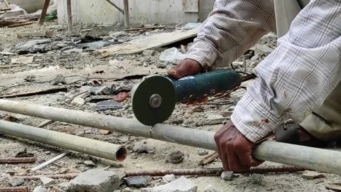 Construction Worker Cutting Metal Pipe Stock Footage 170982717