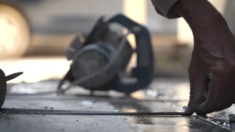 Construction worker cutting stone using industrial machine Stock Footage 319074182