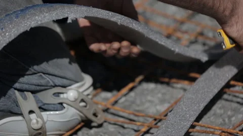 Construction worker cutting stripe of foam Video stock 63916794