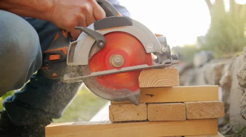 Construction worker cutting wood with circular electric saw. Slow motion. Stock Footage