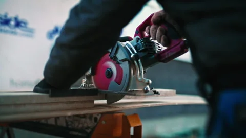 Construction worker cutting wood with circular saw at job site Stock Footage 310162836