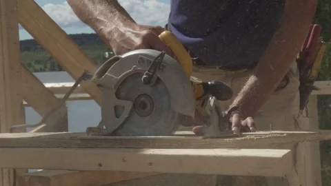 Construction worker cutting wood with a saw Video stock 75792972