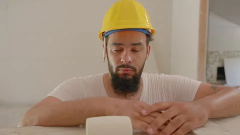 A Construction Worker Deeply Contemplating His Next Steps While on a Busy Job Stock Footage 305443330