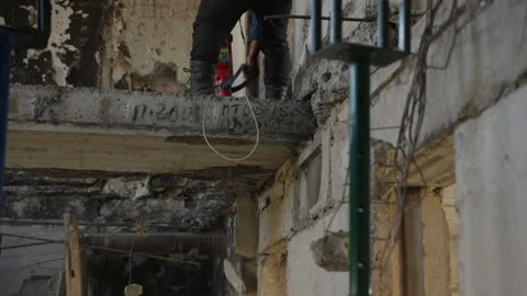Construction worker demolishes war-torn apartment with jackhammer. Man clearing Stock Footage 281409333