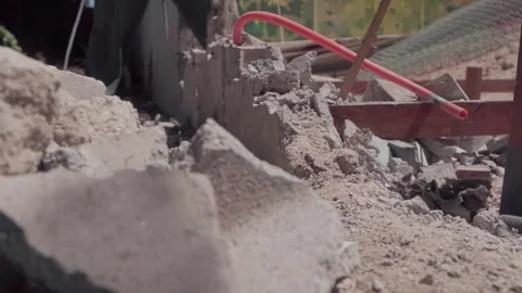 Construction worker demolishing concrete pillar with jackhammer Stock Footage 345551055