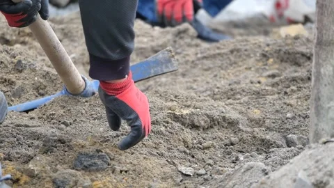 Construction worker digging dirt with pickaxe and shovel outdoors. Stock Footage 332626877