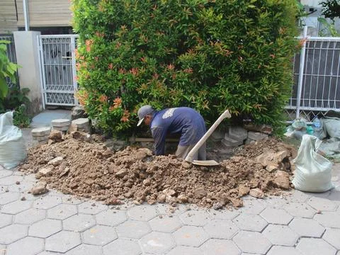Construction worker digging trench using shovel, hole for wall foundation o.. Stock Photos