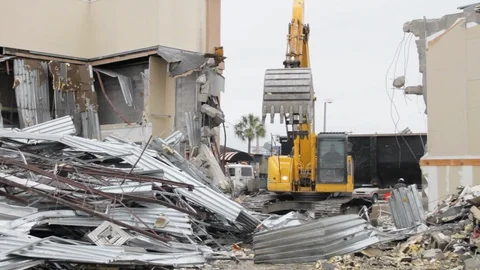 Construction worker digs up scraps inside destroyed building at demolition s 스톡 동영상 125056558