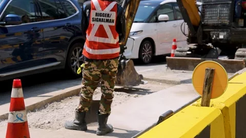 Construction Worker Directs Traffic at Urban Roadwork Site Stock Footage 315743086