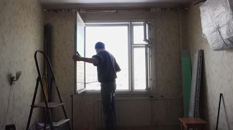Construction worker dismantles and removes the old window. 4K. Stock-Footage 62082246