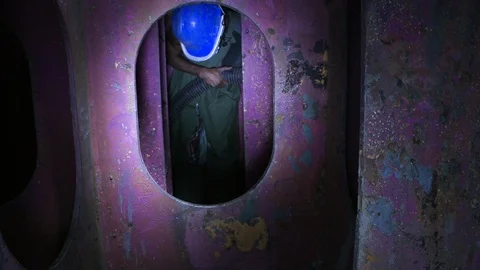Construction worker doing close quarters work in metal tunnel or pipe 3 Stock Footage 123722414