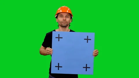 Construction worker doing presentation with blank board on green screen Stock Footage 130794597