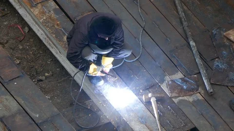 Construction worker doing welding on girder in a construction site Stock Footage 96131277