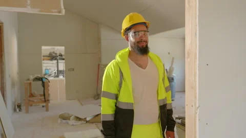 A Construction Worker Dressed in Safety Gear at Their Job Site, Focusing on Видео 310284648