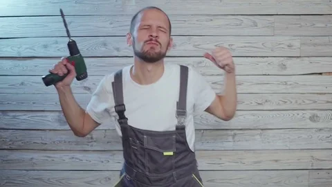 Construction worker with a drill in his hand dancing fun Video stock 81945897
