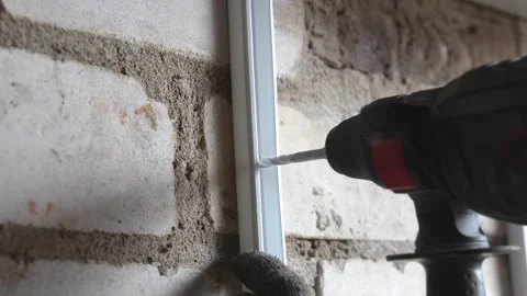 Construction worker drilling hole into brick wall Stock-Footage 333696259