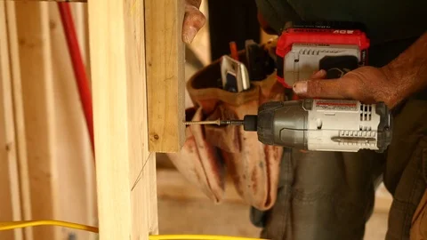 Construction Worker Drilling Screw into Wood inside House Stock Footage 104890267