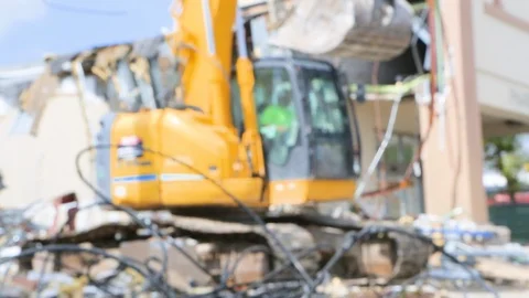 Construction worker drives controls heavy equipment at demolition site C Stock Footage 125055564