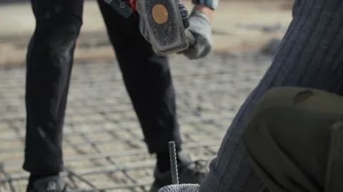 Construction worker driving rebar with heavy sledgehammer Stock Footage 310406849