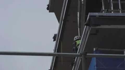 Construction worker ducks down out of sight Stock Footage 93202496